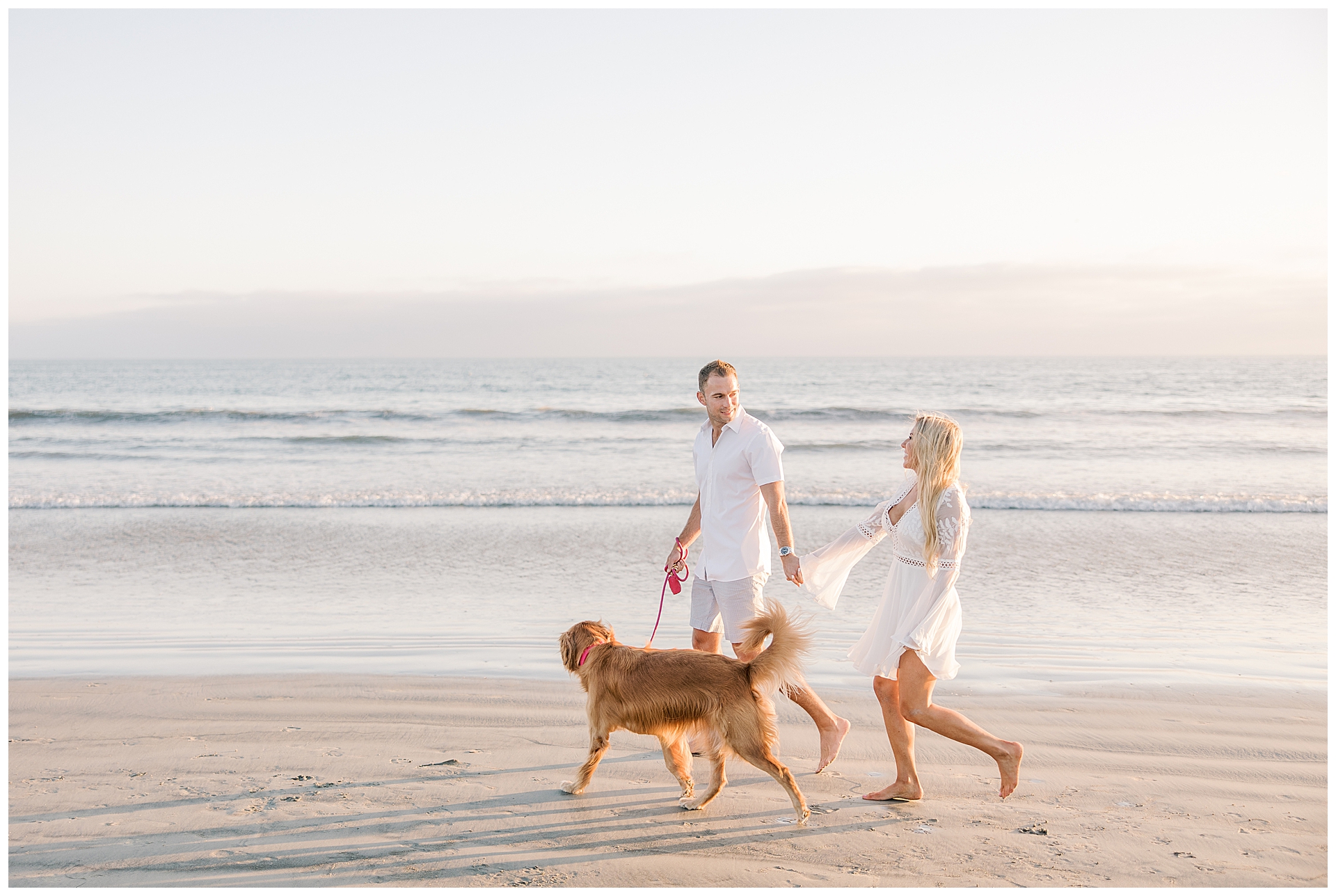 Couple with their golden retriever walking on the beach at Coronado Beach