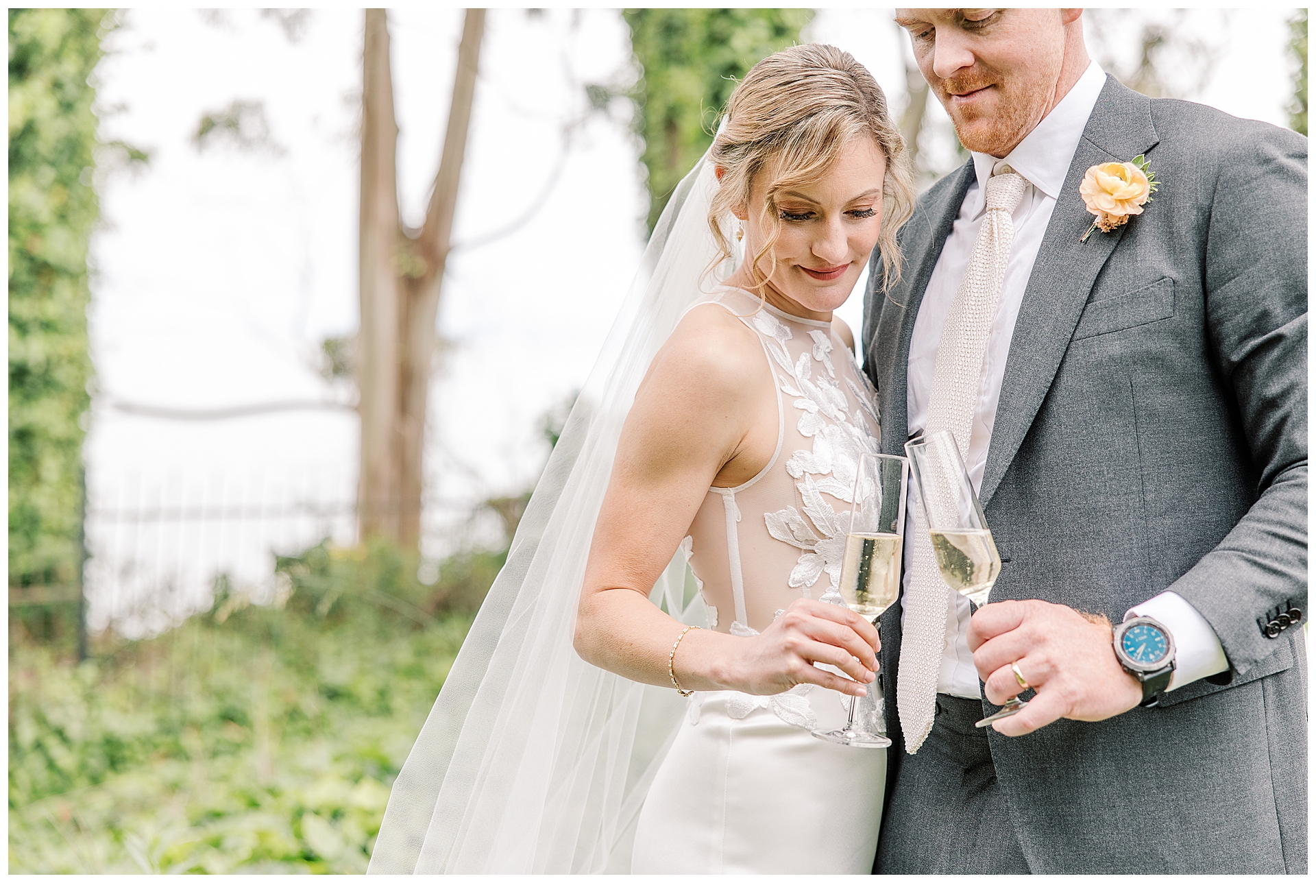 Bride and Groom at Monarch Cove Inn Santa Cruz, cheers with champagne.