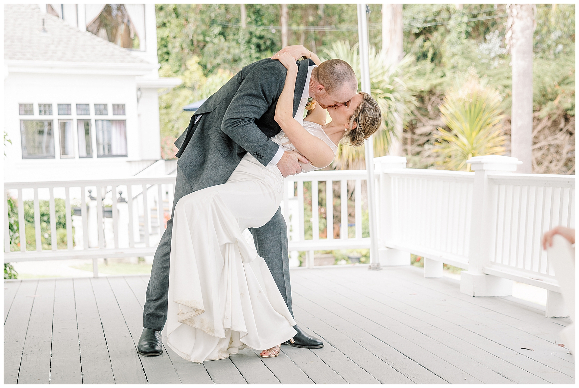 Bride and Groom share a dip kiss at the end of their first dance on the deck of Monarch Cove Inn. 