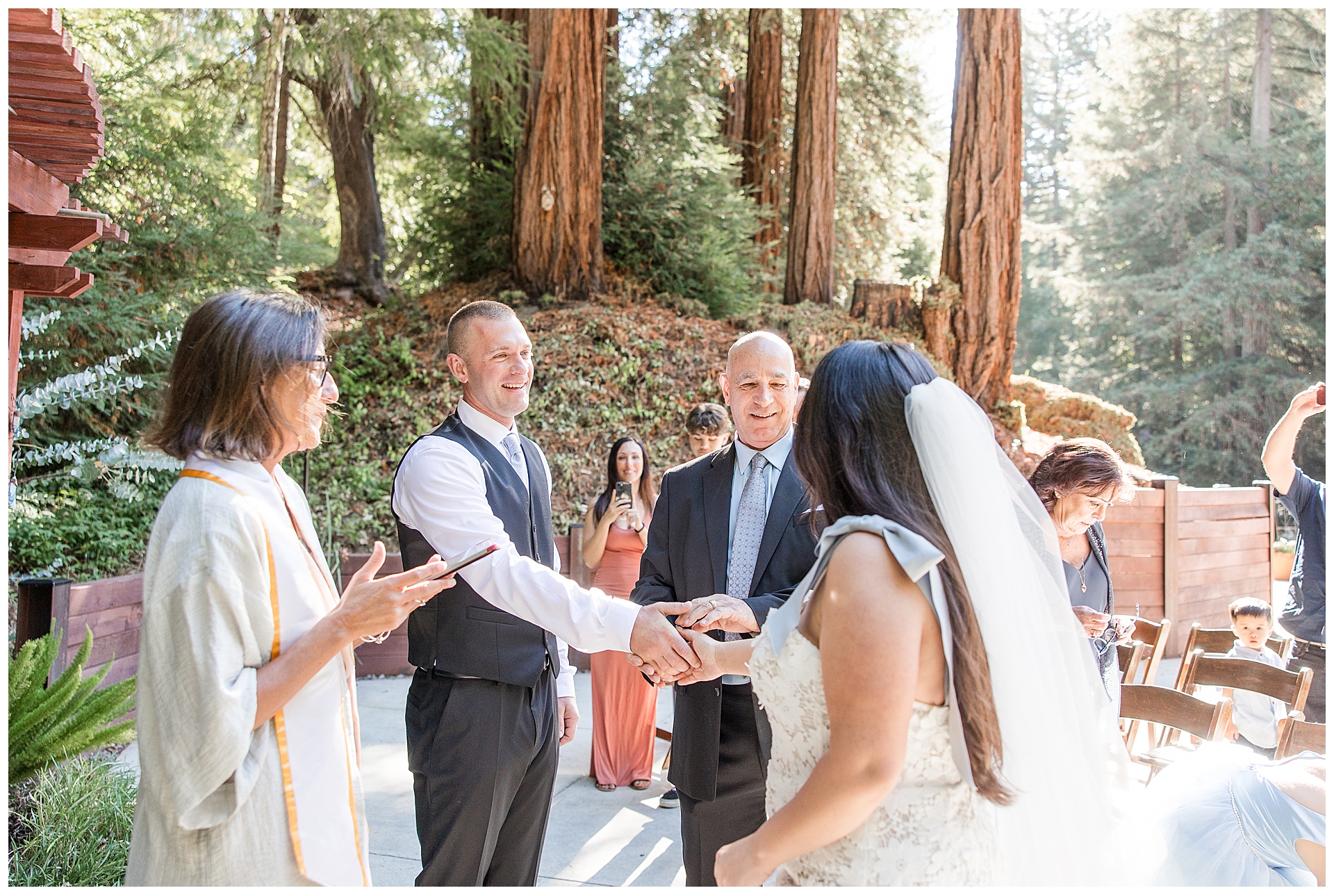 Dad giving the bride away to the groom at their redwood forest wedding.