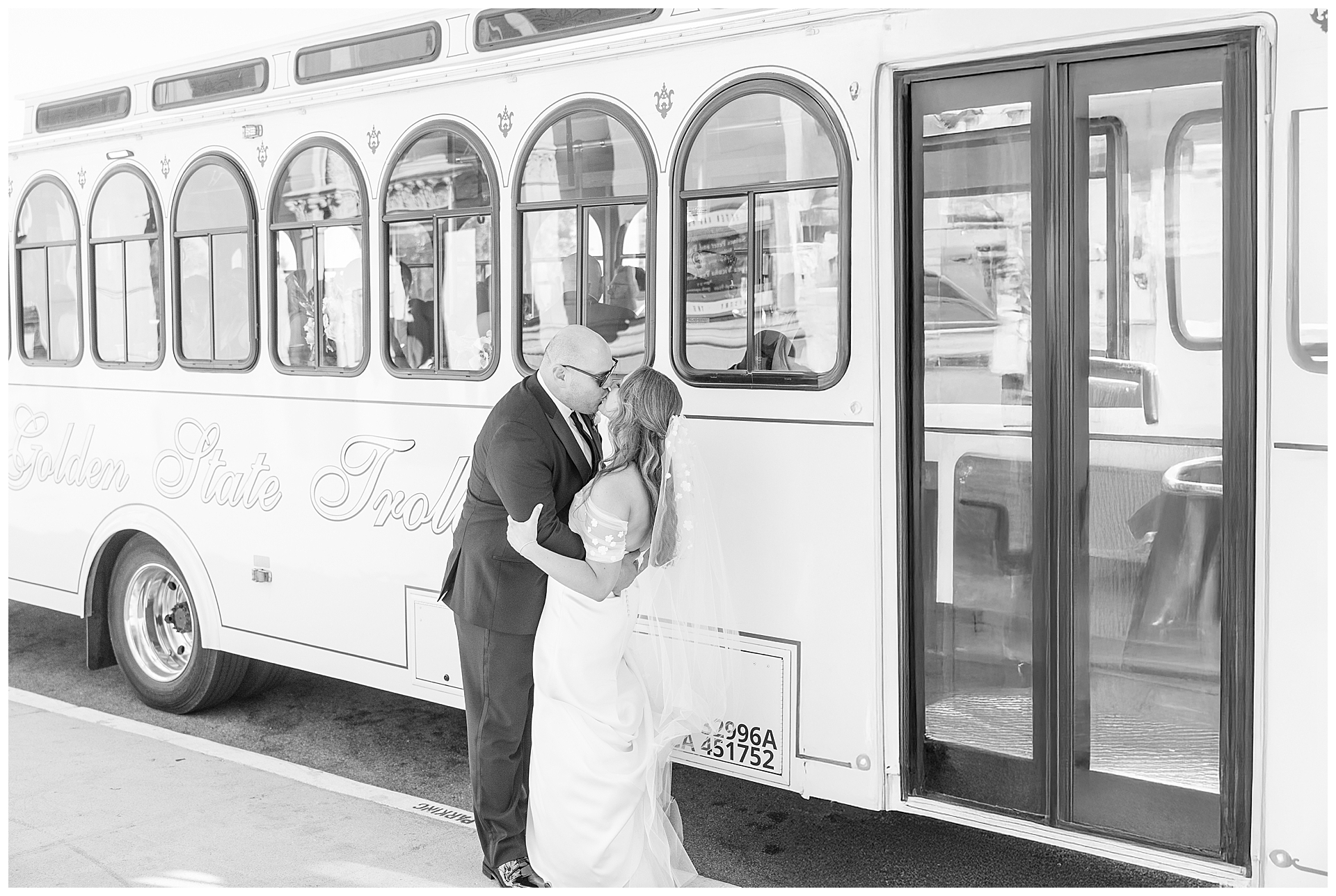 Bride and Groom kissing in front of a San Francisco Trolly