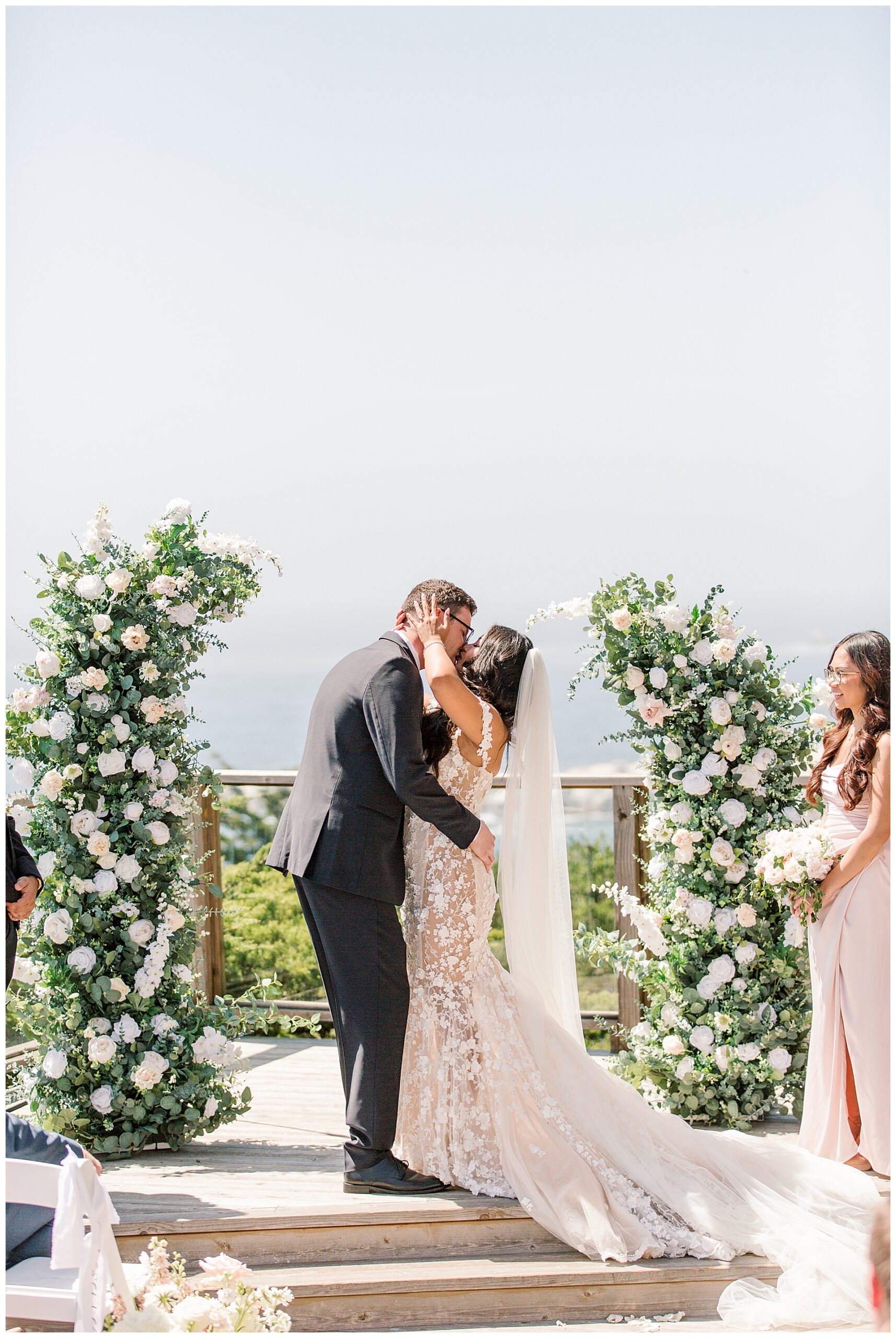 A bride and groom share their first kiss at their wedding ceremony 