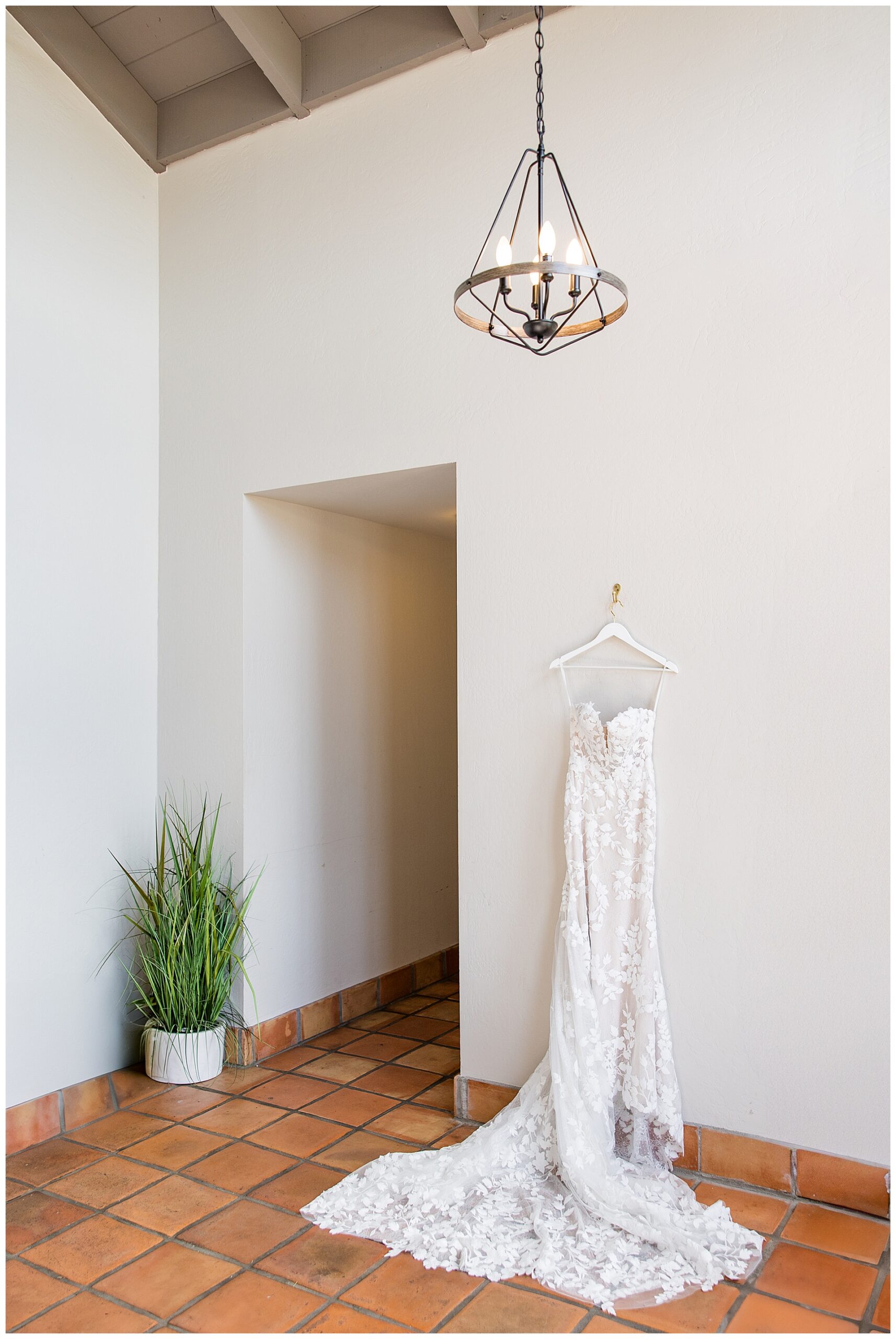 Lace Wedding dress hanging on a wall at Wedgewood Carmel. Tips for wedding dress shopping.